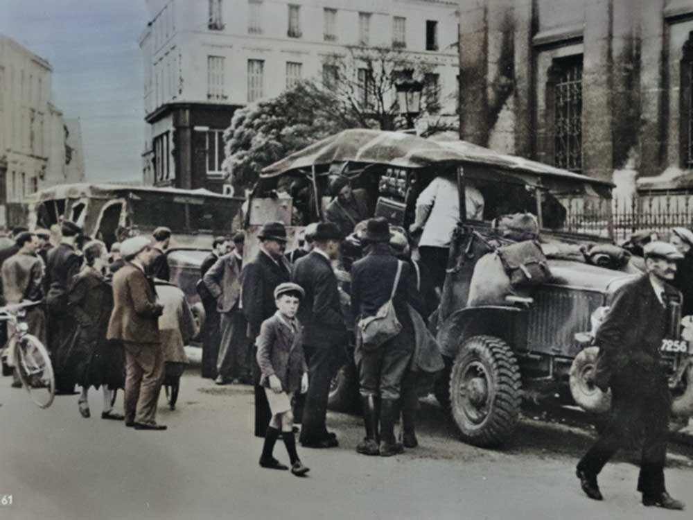 In long columns, the frightened refugees return home, 1940.